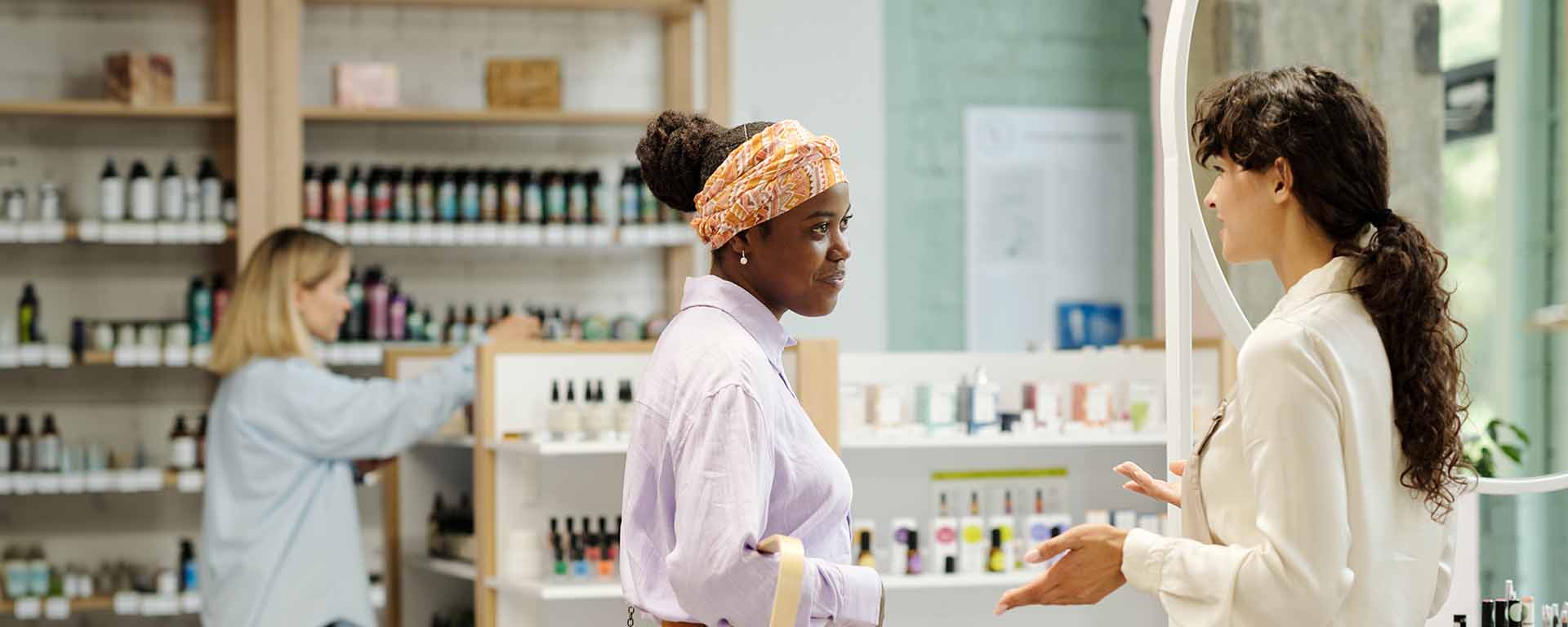 Customer and shop assistant having a conversation in a modern beauty store.