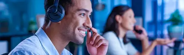 Customer service representative wearing a headset, assisting clients